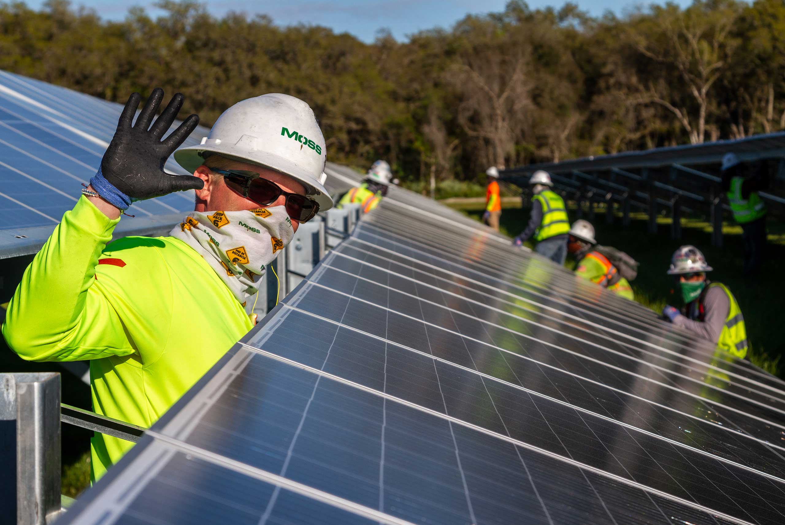 Workers installed solar panels on a project site.